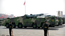 FILE - Chinese military vehicles carrying DF-17 ballistic missiles roll during a parade to commemorate the 70th anniversary of the founding of Communist China in Beijing, on Oct. 1, 2019.