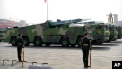 FILE - Chinese military vehicles carrying DF-17 ballistic missiles roll during a parade to commemorate the 70th anniversary of the founding of Communist China in Beijing, on Oct. 1, 2019.