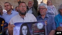 FILE - Palestinian Prisoners Committee members rally outside the International Committee of the Red Cross office in Gaza City on July 17, 2023, demanding the Iraqi government include Palestinian prisoners in the exchange for academic Elizabeth Tsurkov.