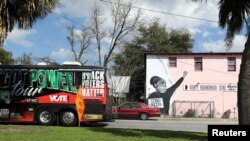 FILE - A mural is displayed as a Black History Month Memorial Ride is held in memory of those who have died through race-related violence, organized by the family of shot Black man Ahmaud Arbery, in Brunswick, Georgia, U.S., Feb.27, 2021. 