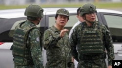 FILE - Taiwan President Lai Ching-te, center, listens to an officer as he inspects the annual Han Kuang military exercises in Hualien county, eastern Taiwan, July 23, 2024. On Friday, Lai is set to visit the sensitive Kinmen islands that sit next to the Chinese coast.