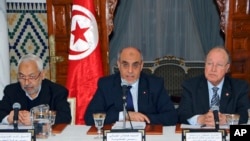 FILE - Tunisian former Prime Minister Hamadi Jebali, center, delivers his speech Friday, Feb. 15, 2013, in Carthage, outside Tunis.