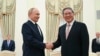 Russian President Vladimir Putin, left, and Chinese Premier Li Qiang shake hands during their meeting at the Kremlin in Moscow, Russi, Aug. 21, 2024. 