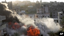 Smoke and fire rise from an explosion caused by an Israeli airstrike targeting a building in Gaza on May 13, 2023. The building was owned by an Islamic Jihad official.