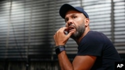 French-Algerian choreographer Mourad Merzouki guides his dancers as they rehearse for "Dance of the Games" at the concert hall in Creteil, east of Paris, July 31, 2024.