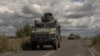 Ukrainian armored military vehicles drive from the direction of the border with Russia, in Ukraine's Sumy region, Aug. 13, 2024.