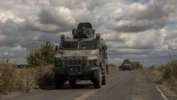 Ukrainian armored military vehicles drive from the direction of the border with Russia, in Ukraine's Sumy region, Aug. 13, 2024.