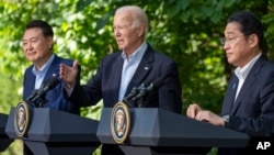 President Joe Biden, center, speaks with Japanese Prime Minister Fumio Kishida, right, and South Korean President Yoon Suk Yeol during a joint news conference, Aug. 18, 2023, at Camp David in Maryland. 