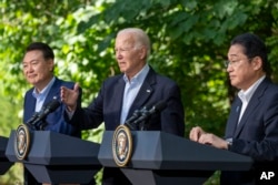 FILE - President Joe Biden, center, speaks with Japanese Prime Minister Fumio Kishida, right, and South Korean President Yoon Suk Yeol during a joint news conference, Aug. 18, 2023, at Camp David in Maryland.