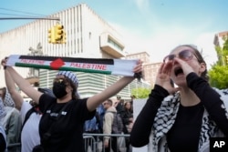 Protesters demonstrate against the war in Gaza outside the entrance to the campus of Columbia University in New York, April 30, 2024.