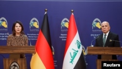 Germany's Foreign Minister Annalena Baerbock and Iraq's Foreign Minister Fuad Hussein attend a joint news conference in Baghdad, Iraq, March 7, 2023. 