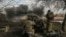 Ukrainian servicemen fire a 105mm Howitzer towards Russian positions, near the city of Bakhmut, March 4, 2023. 