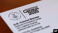 FILE - An envelope containing a 2020 census letter mailed to a U.S. resident sits on a desk on April 5, 2020, in Detroit. 