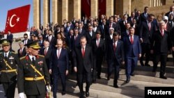 Turkey's President Recep Tayyip Erdogan, center, is seen the Republic Day ceremony at the mausoleum of modern Turkey's founder, Mustafa Kemal Ataturk, to mark the 100th anniversary of the republic's founding, in Ankara, Turkey, Oct. 29, 2023.