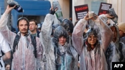 FILE: Climate protesters pour oil over themselves as scuffles between police and protesters broke out with the use of tear gas during a demonstration on the outskirts of the Paris venue for TotalEnergies Annual General Meeting in Paris.