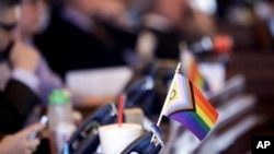 FILE - A flag supporting LGBTQ+ rights decorates a desk at the Statehouse in Topeka, Kansas, March 28, 2023. The U.S. Supreme Court agreed to weigh in on gender-affirming care.