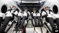 From left, Konstantin Borisov (Russia), Andreas Mogensen (European Space Agency) Jasmin Moghbeli (NASA), and Satoshi Furukawa (Japan Aerospace Exploration Agency) are seen aboard the SpaceX recovery ship MEGAN, March 12, 2024. (Joel Kowsky/NASA via AP)