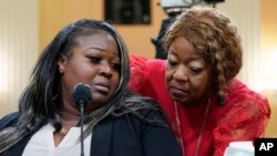 FILE - Wandrea 'Shaye' Moss, a former Georgia election worker, and her mother, Ruby Freeman, right, in Washington, June 21, 2022.