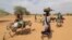 Sudanese families fleeing the conflict in Sudan's Darfur region make their way through the desert after they crossed the border between Sudan and Chad to seek refuge in Goungour, Chad, May 12, 2023.