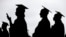 FILE - College graduates line up before the start of commencement in New Jersey, May 17, 2018. More than 40 million Americans will be on the hook for federal student loan payments starting in late August under the terms of a debt ceiling deal approved by Congress last week.