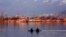 Kashmiri boatmen row their shikara (wooden boats) alongside the famous houseboats in the state’s most popular tourist spot: Dal Lake, Srinagar. (Muzamil Mattoo/VOA)
