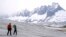 Team members of ETH (Swiss Federal Institute of Technology) glaciologist and head of the Swiss measurement network 'Glamos', Matthias Huss, drill holes into the Rhone Glacier to take measurements near Goms, Switzerland, June 16, 2023.