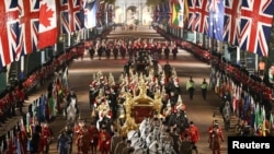 The Gold State Coach is ridden alongside members of the military during a full overnight dress rehearsal of the Coronation Ceremony of Britain’s King Charles and Camilla, Queen Consort in London, Britain.