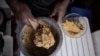 FILE - A private chef prepares cooked beans mashed in boiled sweet potatoes, in Nairobi, Kenya, Dec. 16, 2021.