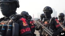 FILE - Counterterrorism police officers march during a show of force in Jakarta, Indonesia, Sept. 1, 2023.