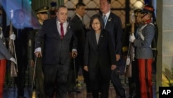 Taiwan's President Tsai Ing-wen and Guatemala's President Alejandro Giammattei arrive to deliver a joint statement at the National Palace in Guatemala City, March 31, 2023. 