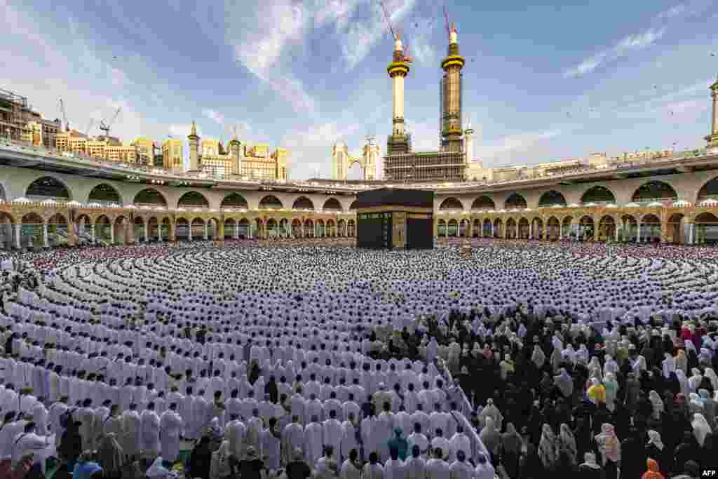 Muslim worshippers pray around the Kaaba, Islam's holiest shrine, at the Grand Mosque in the holy city of Mecca on the first day of Eid al-Fitr, which marks the end of the holy fasting month of Ramadan.