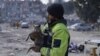 A man holds a cat he rescued from a building as rescuers extract the bodies of victims from collapsed buildings in Antakya, Turkey, on Feb. 15, 2023, nine days after a 7.8-magnitude struck the country.