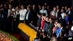 Cambodian Prime Minister Hun Sen, center right, waves to the crowd as he presides over the opening ceremony of the 32nd Southeast Asian Games in Morodok Techo National Stadium outside Phnom Penh Cambodia, May 5, 2023.