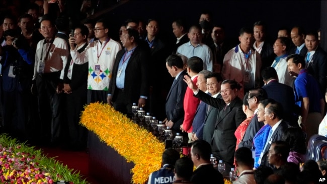 Cambodian Prime Minister Hun Sen, center right, waves to the crowd as he presides over the opening ceremony of the 32nd Southeast Asian Games in Morodok Techo National Stadium outside Phnom Penh Cambodia, May 5, 2023.