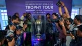 Photographers take pictures during a trophy tour of the upcoming ICC Men's Cricket World Cup at the Rajiv Gandhi International Cricket Stadium in Hyderabad, India, Sept. 21, 2023. 