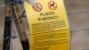 FILE - In this Aug. 10, 2019 photo, a sign warning of bubonic plague is displayed at a parking lot near the Rocky Mountain Arsenal Wildlife Refuge in Commerce City, Colo. 