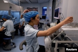 Embryologists work on creating viable embryos to be either used in an in vitro fertilization transfer or frozen for later use in a laboratory at the Stork Fertility Clinic in Hsinchu, Taiwan, May 16, 2023. (REUTERS/Ann Wang)