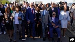 President Joe Biden talks with Congresswoman Terri Sewell, center, and the Rev. Al Sharpton after walking across the Edmund Pettus Bridge in Selma, Alabama, March 5, 2023, to commemorate the 58th anniversary of "Bloody Sunday."