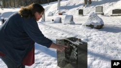 FILE - Deb Walker, of Chester, Vermont, visits the grave of her daughter Brooke Goodwin, Dec. 9, 2021, in Chester. Goodwin, 23, died in March of 2021 of a fatal overdose of the powerful opioid fentanyl and xylazine. 