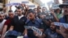 Mourners and colleagues holding "press" signs surround the body of Al Jazeera journalist Ismail al-Ghoul, killed along with cameraman Rami al-Rifi in an Israeli strike during their coverage of Gaza's Shati refugee camp, on July 31, 2024.