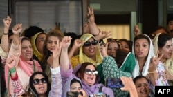 Supporters of former prime minister Imran Khan's Pakistan Tehreek-e-Insaf (PTI) party celebrate after a Supreme Court verdict outside the court building in Islamabad on July 12, 2024.