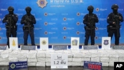 Police officers stand behind seized crystal methamphetamine during a news conference in Bangkok, Thailand, May 29, 2023.