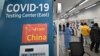 Health workers guide travelers arriving from China at a COVID-19 testing center at Incheon International Airport, west of Seoul on Jan. 3, 2023.