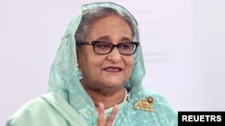 Sheikh Hasina, Prime Minister of Bangladesh and Chairperson of Bangladesh Awami League, shows a victory sign while speaking to the press in Dhaka, Bangladesh, January 7, 2024. Prime Minister's office/Handout via REUTERS