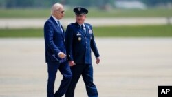U.S. President Joe Biden, escorted by 89th Airlift Wing Commander, Air Force Colonel Matthew Jones, walks to Air Force One at Andrews Air Force Base, Maryland, May 17, 2023, for his trip to Hiroshima, Japan, to attend the G7.