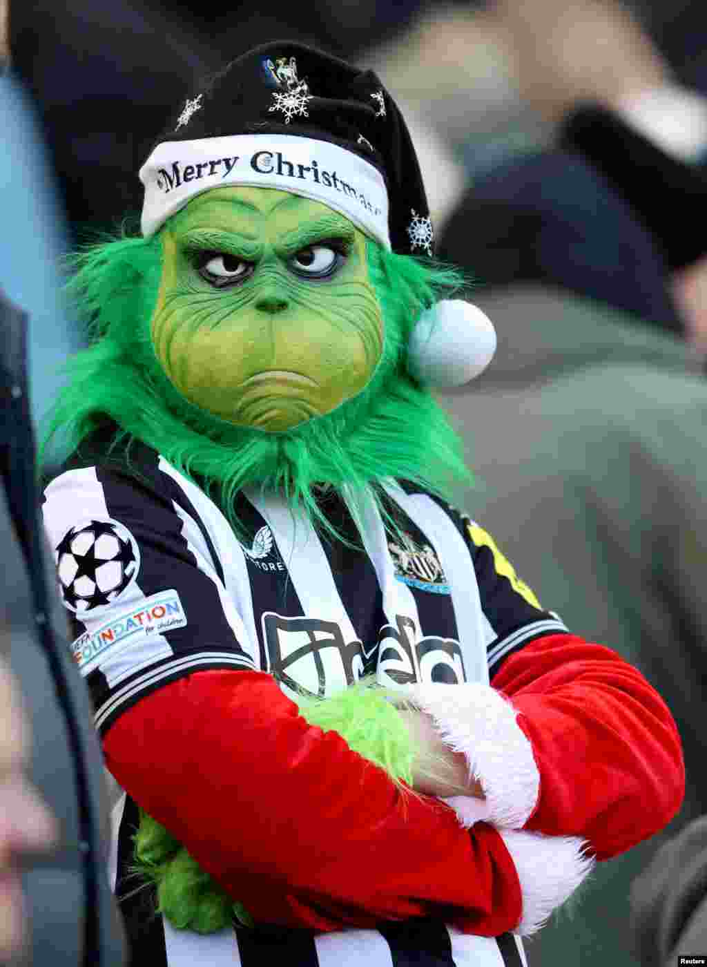 Penggemar Newcastle United mengenakan topeng Grinch saat menghadiri pertandingan sepak bola Liga Utama Inggris antara Newcastle United dan Nottingham Forest di St. James &#39;Park di Newcastle-upon-Tyne, Inggris.