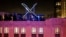 FILE - Workers install lighting on an "X" sign atop the company headquarters, formerly known as Twitter, in downtown San Francisco, July 28, 2023. 