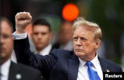 Former U.S. President Donald Trump pumps a fist outside Trump Tower after the verdict in his criminal trial over charges that he falsified business records, in New York City, May 30, 2024.
