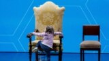 A child climbs Pope Francis' seat at "The General State of the Birth Rate" conference on Italy's sliding birthrate, in Rome, Italy.