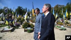 In this photo provided by Ukraine's Foreign Ministry, U.S. Secretary of State Antony Blinken, right, and Ukrainian Foreign Minister Dmytro Kuleba, walk at the Alley of Heroes at the Berkovetske cemetery in Kyiv, Ukraine, Sept. 6, 2023.